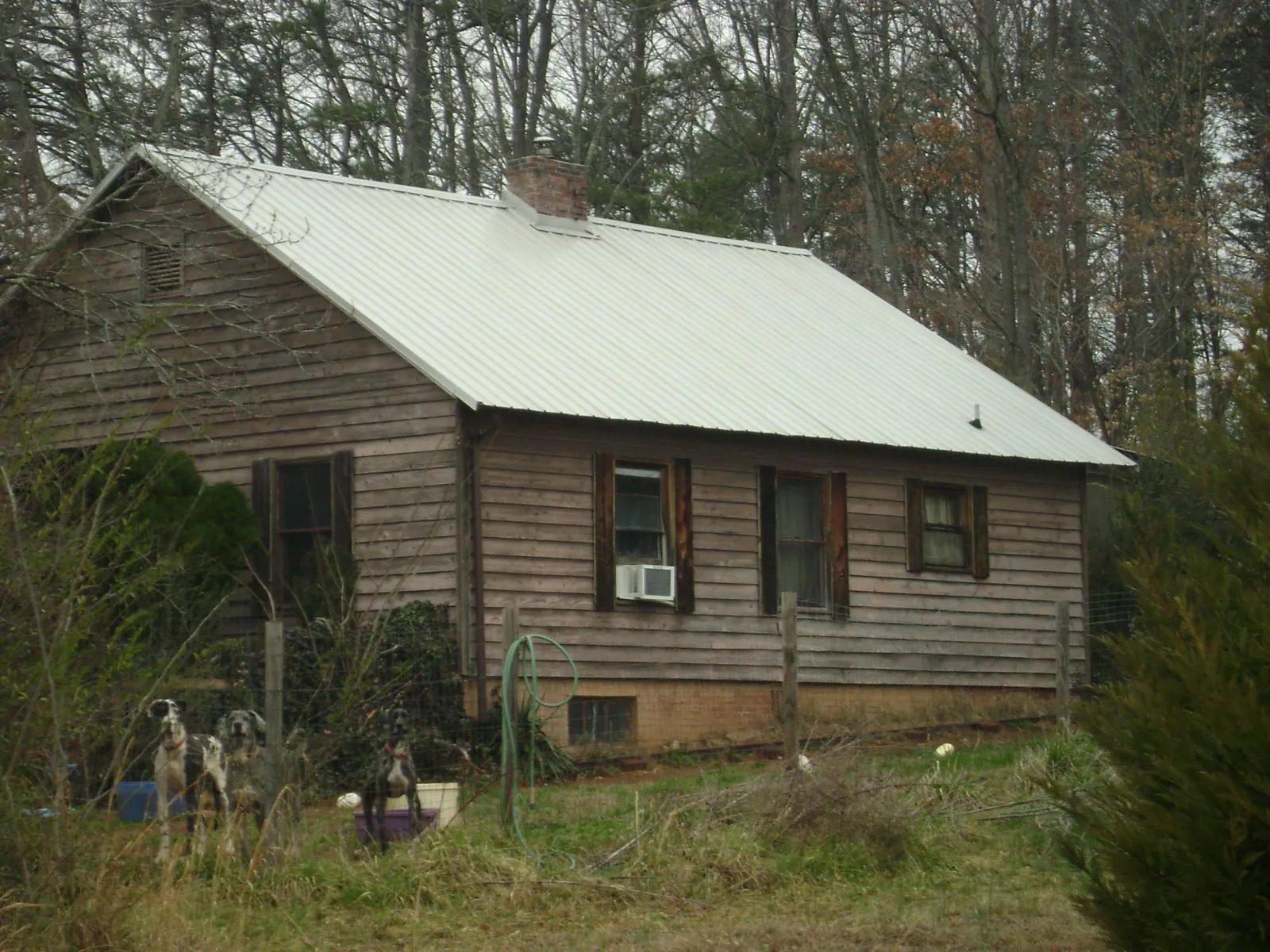 White metal roof on an old wood sided farmhouse, from a Metal Roof Installation job in North Prairie